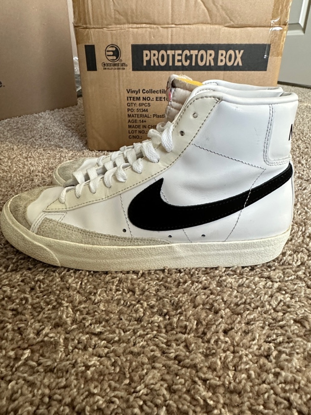 Nike High-Top Sneakers in White with Black Swoosh
